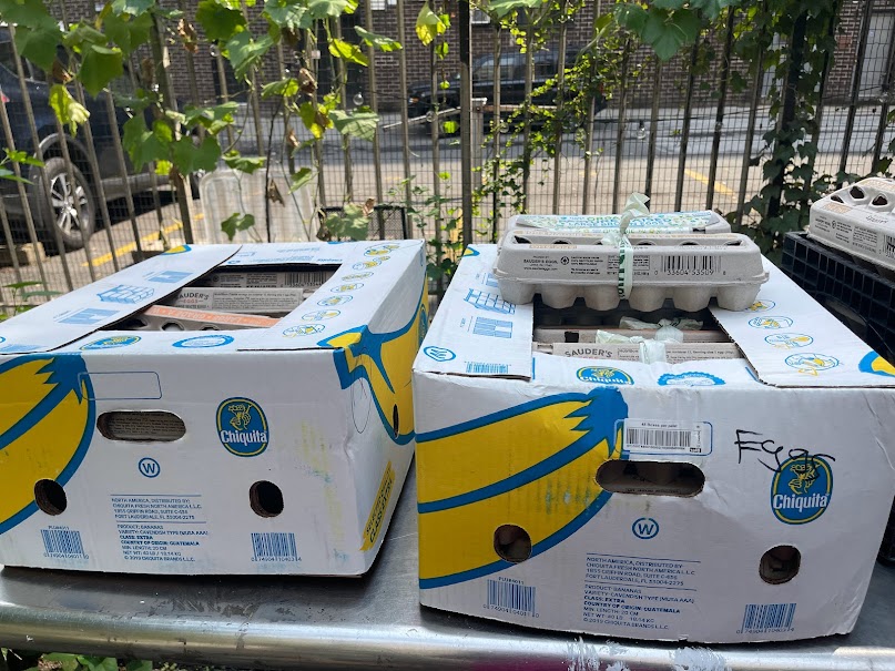 Produce boxes and eggs set aside for pickup and distribution